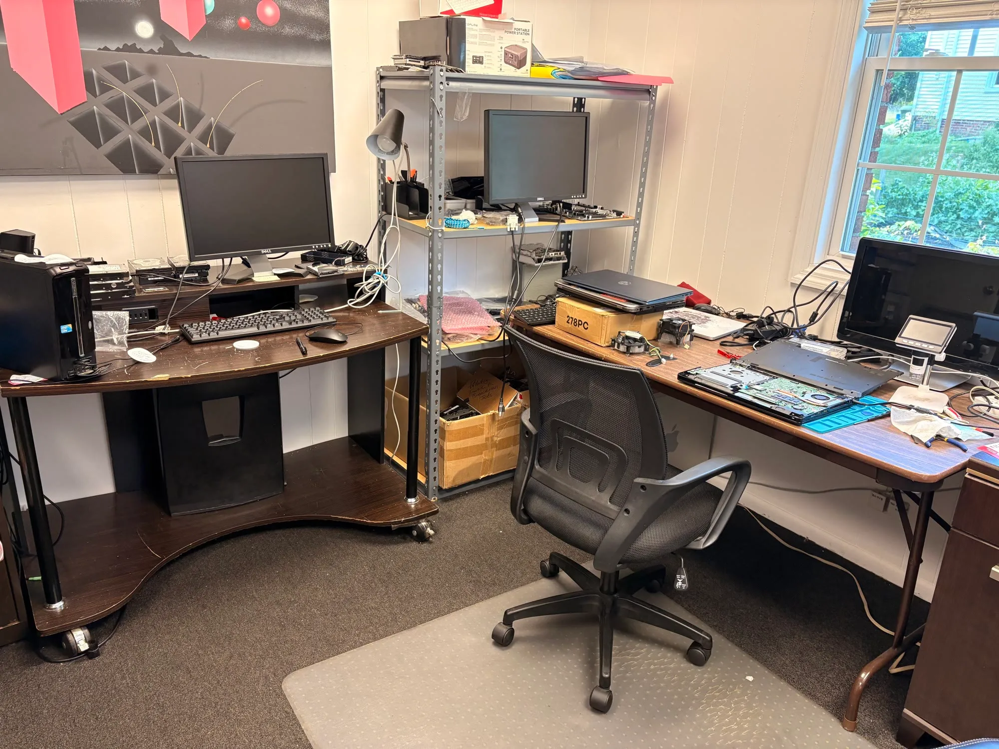 A laptop opened up on the JY Computer Services repair bench for board-level diagnosis
